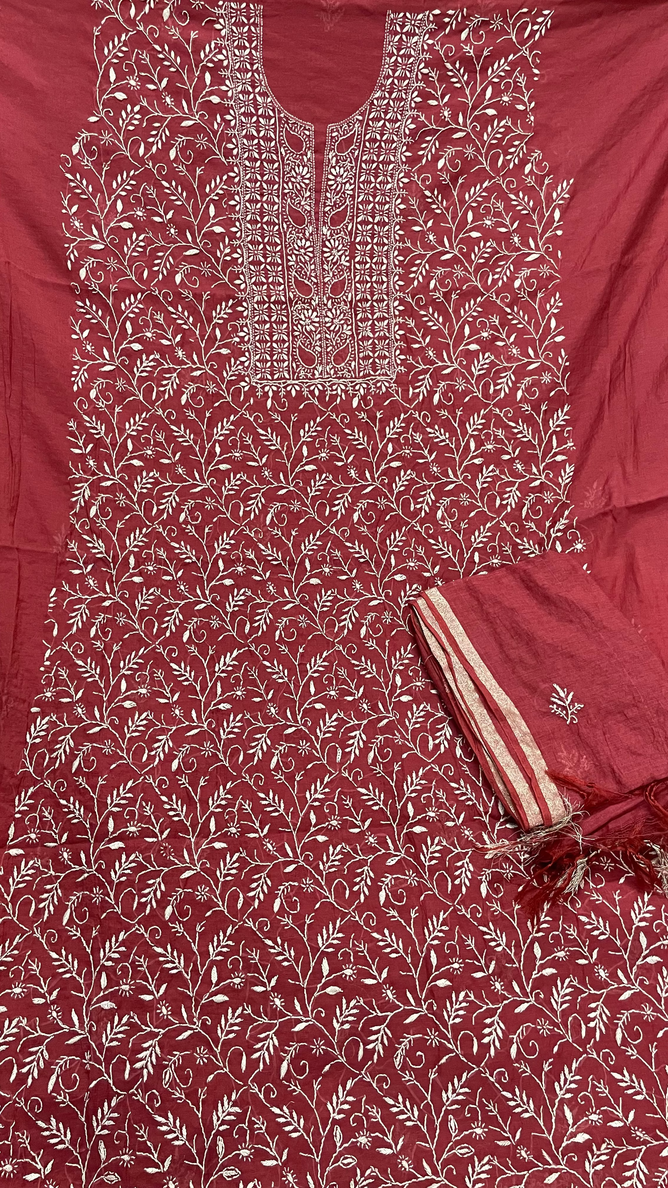Maroon fabric with intricate white floral patterns