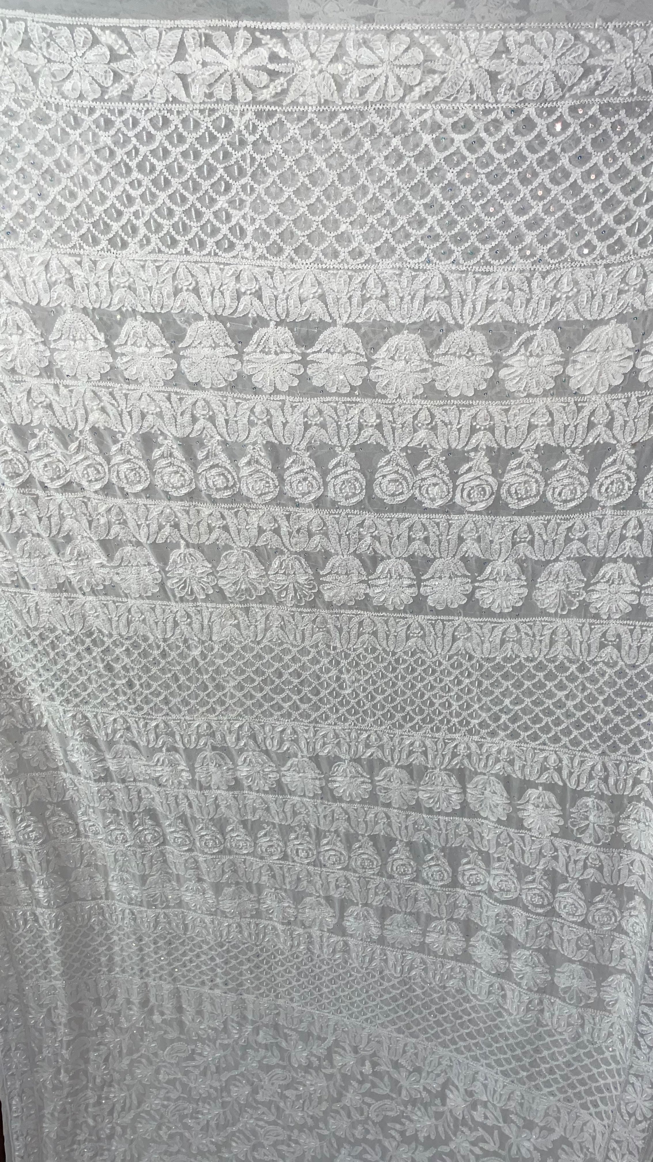 Close-up of a textured fabric with intricate patterns in gray tones.
